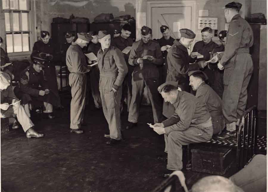 Albert with 1st Battalion Middlesex (he is opening a letter in front of the door). Can you identify any of the other men in this picture?