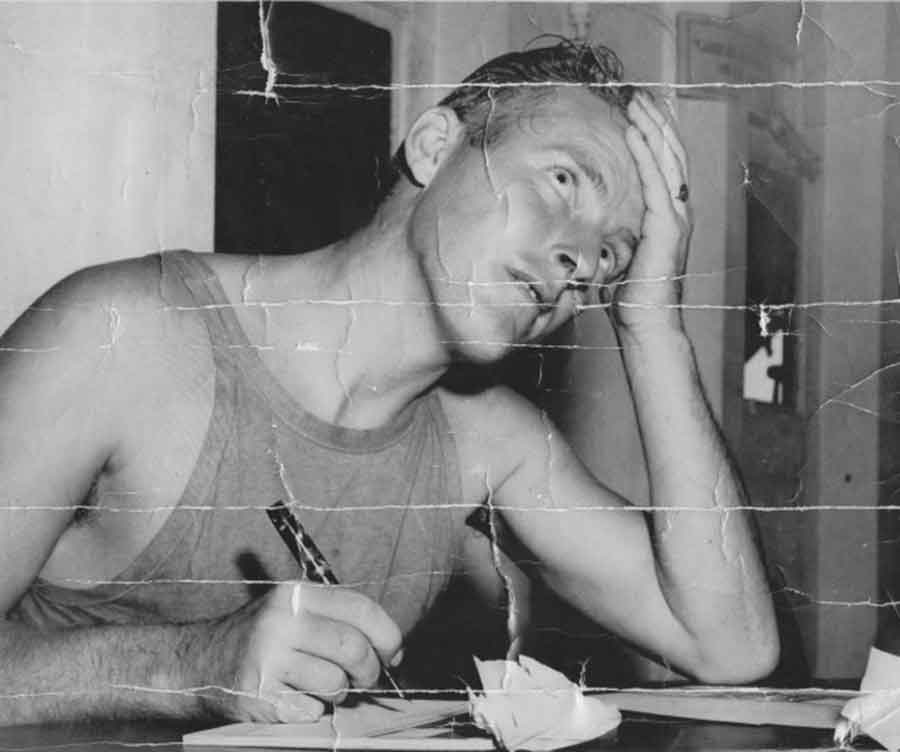 Private Percy Chittenden photographed by the US Army for publicity while aboard the USS Admiral Dickman, bound for Hawaii. The photograph was captioned Private Percy Chittenden... tries to compose a cablegram to send to the folks back home as the ship which is carrying him in the first stage of his return to England docks at Honolulu