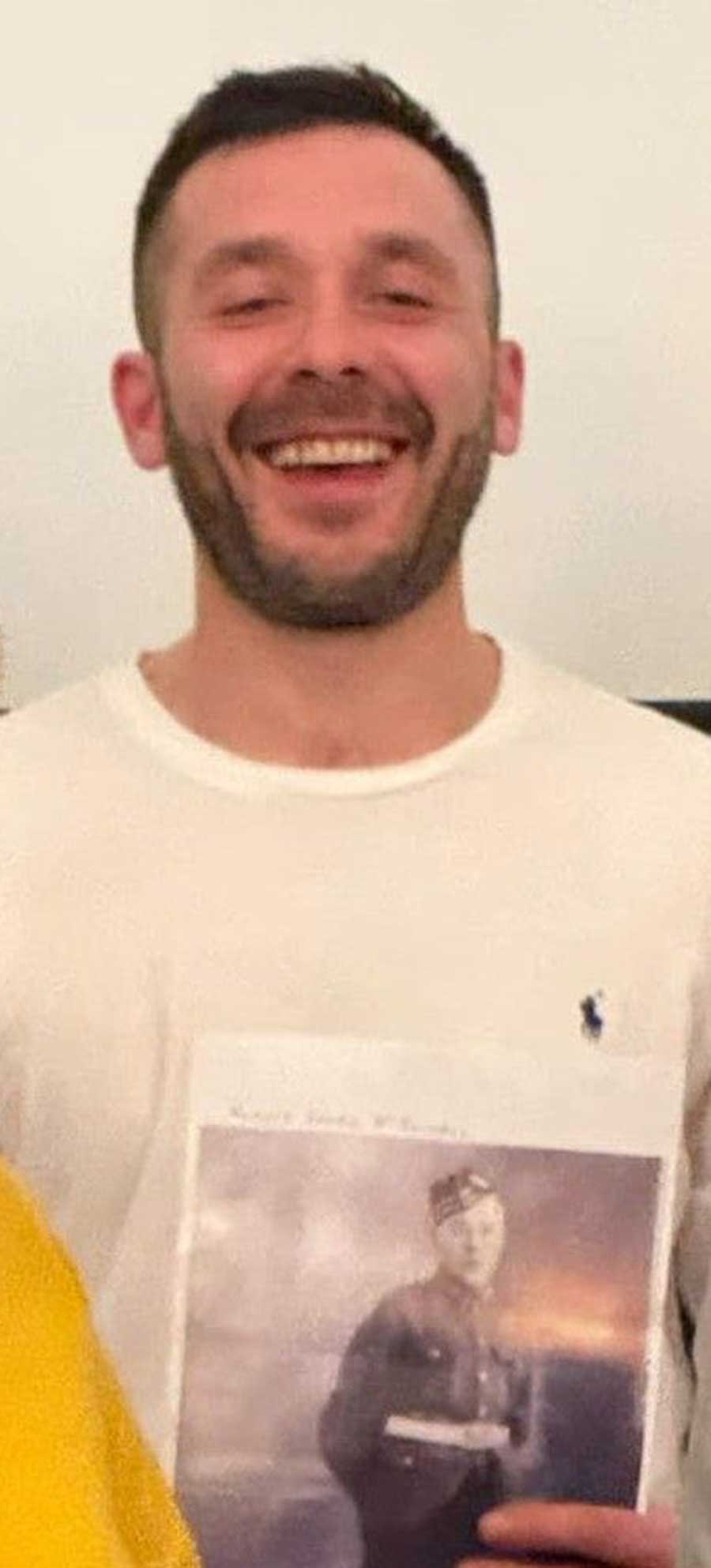 Michael, grandson of James McDougall, pictured with his grandfather's photograph at the showing of the film The Sinking of the Lisbon Maru at the Royal Scots