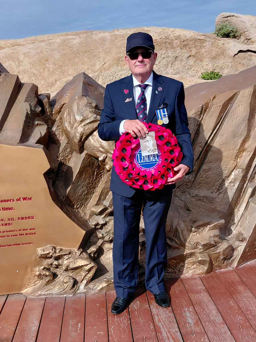 Robert Golding son of William (Bill) Golding with a wreath commemorating his father at the Chinese Memorial Qingbang Island, Dongji Town, Zhoushan, East China in May 2026. Bill was a Far East Prisoner of War and survivor of the sinking of the Lisbon Maru.