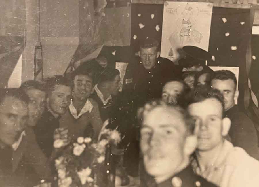 The men pictured at the same dinner where Lieutenant Colonel Stewart is speaking.